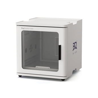 A white PopStation mini home theater system enclosure with a transparent front window, shown on a clean white background. The side of the unit features a dark blue 'BQ' logo.